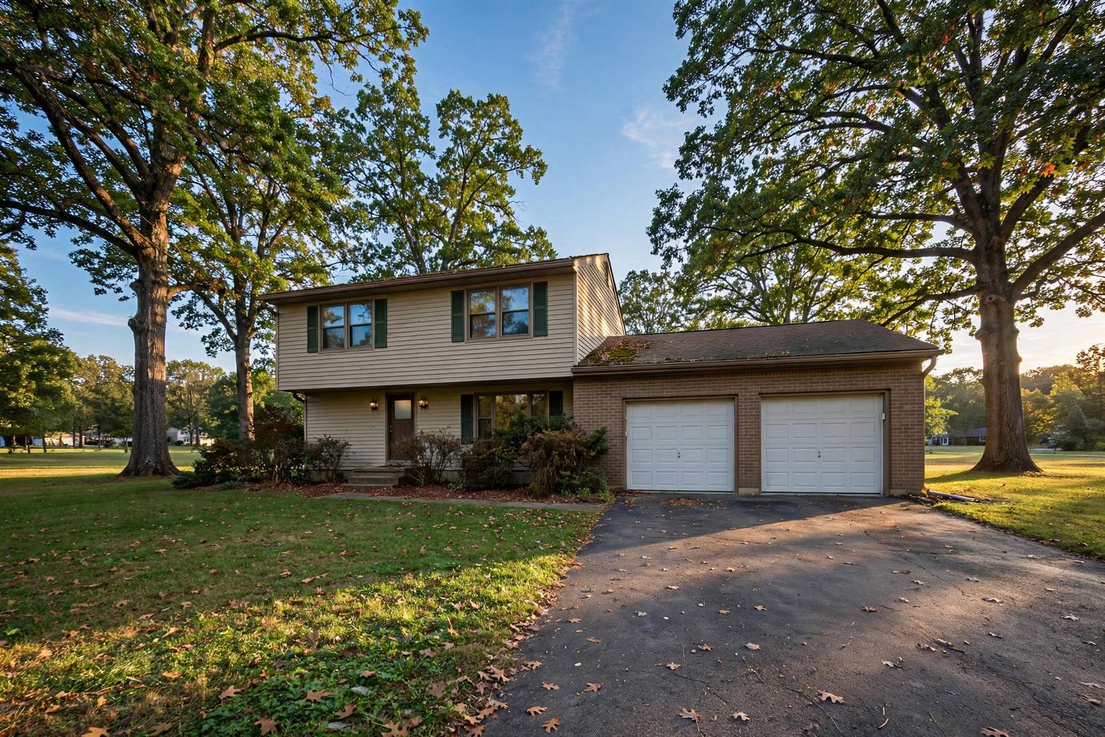 Split-level suburban home with mature trees on a large lot